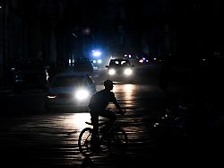 a man rides his bicycle down a street during a blackout in havana on august 1 2026
