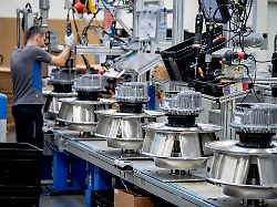 a man works on fans at an ebm papst plant in hollenbach germany tuesday feb 4 2025