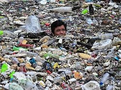 a worker collects garbage that washed into a river amid heavy southwest monsoon rains near baclaran church in paranaque city metro manila philippines august 11 2026