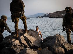 ceuta spain july 31 2026 migrants gather near the tarajal border crossing in ceuta as spanish security forces monitor the area during the afternoon