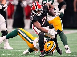 file atlanta falcons running back bijan robinson top front runs over green bay packers linebacker quay walker bottom during the first half of an nfl football game sept 17 2023 in atlanta