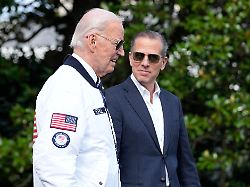 file president joe biden wearing a team usa jacket and walking with his son hunter biden heads toward marine one on the south lawn of the white house in washington july 26 2024