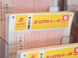 mehrere lotto spielscheine liegen in einer auslage