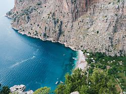 nestled between towering cliffs butterfly valley in fethiye turkey offers stunning turquoise waters and lush greenery a perfect spot for relaxation hiking and exploring nature s wonders
