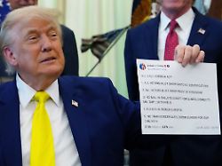 president donald trump holds up an image taken from his truth social account at an event about coal thursday june 4 2026 in the oval office of the white house in washington