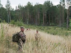servicemen of the latvian national guard walk on a field as they search for the debris from an intercepted drone amid russia s attack on ukraine in rugaji latvia august 14 2026