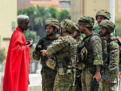 spanish soldiers question a migrant following mass crossings of migrants on foot and by sea from morocco into spanish territory in ceuta spain august 1 2026
