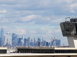 the new york city skyline is seen behind an air traffic control tower at newark international airport in newark n j thursday nov 6 2025