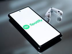 the spotify logo appears on a smartphone screen next to wireless earbuds in this illustration photo taken in athens greece on february 17 2026
