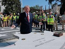 u s president donald trump gestures by a stone that will be inserted into the helipad that is being constructed on the south lawn at the white house in washington d c u s august 19 2026