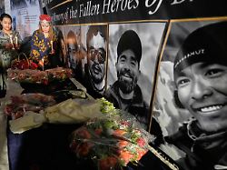 woman place candles next to pictures of climbers who lost their lives on broad peak during a candlelight vigil in their memory in islamabad pakistan tuesday aug 11 2026